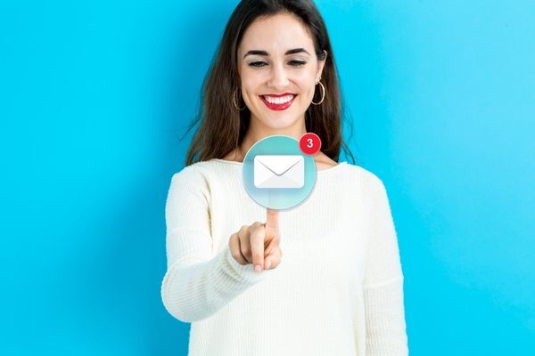 Woman Smiling at Email Icon